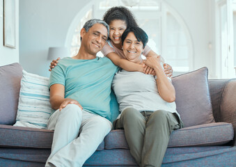 Obraz premium Grandparents, kid and hug in portrait on couch with happiness, love and support in home. Family, care and smile together in living room, apartment or relax on sofa in house with senior couple