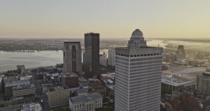 Louisville Kentucky Aerial v64 drone reverse flyover downtown area capturing breathtaking urban cityscape and Ohio river, bathed in golden sunshine - Shot with Mavic 3 Pro Cine - Sept 26th 2023