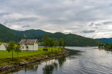 Fototapeta premium Waterfront view from a cruise catamaran on the fjord near Bergen