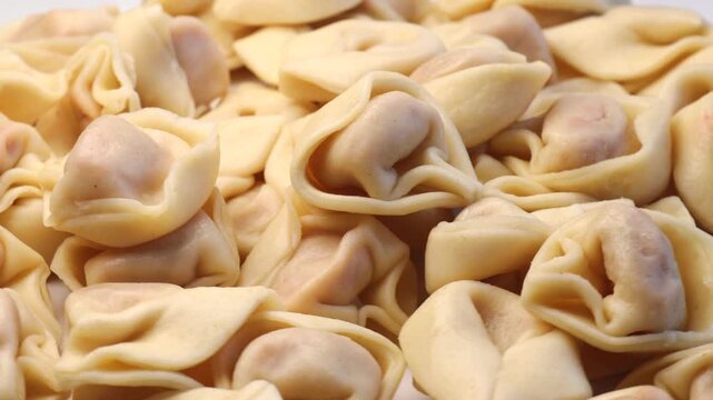 ravioli tortellini stuffed with tomato sauce, rotation in circle. fresh pasta, Turning. Typical Italian dish