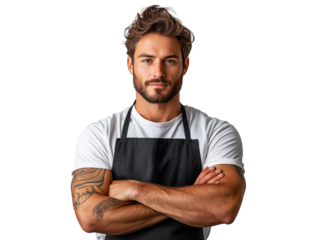 Young male chef in casual attire poses confidently with arms crossed, showcasing a strong physique and tattooed arms
