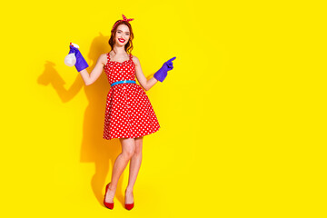 Photo of cheerful adorable pretty lady wear red dress hold bottle empty space isolated on yellow color background