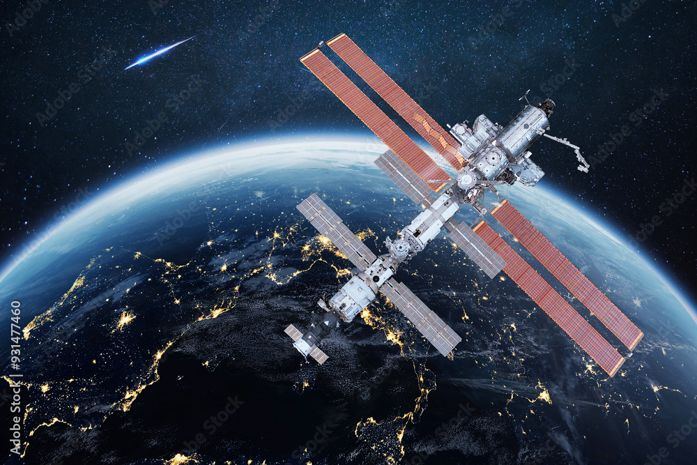 Wall mural the iss flies near blue night planet earth. space mission and space exploration. communications and 