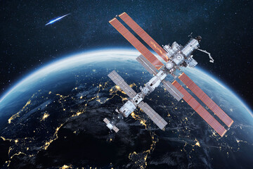 The ISS flies near blue night planet Earth. Space mission and space exploration. Communications and technologies in Earth orbit