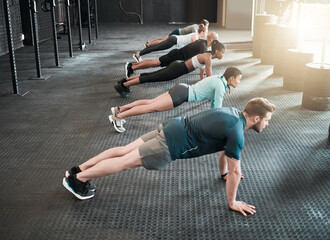 Group, push up and health training for fitness, exercise and gym class, club or core workout for challenge. People, personal trainer or friends collaboration for weight loss, endurance and cardio