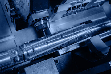 Blue toning, CNC turning production of shafts on factory. Heavy industry background, machine for...