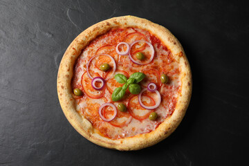 Delicious vegetarian pizza on black table, top view