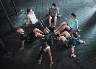 Group, circle and sit ups training for workout, exercise and gym class, club or core fitness for challenge. People, personal trainer or friends collaboration for weight loss, endurance or health