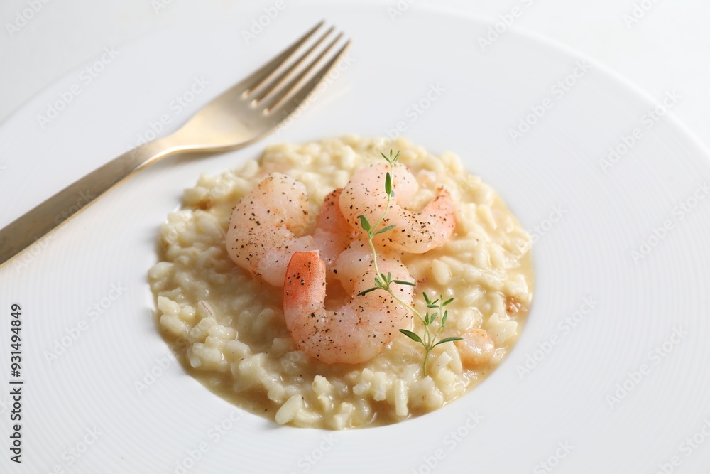 Wall mural Delicious risotto with shrimps and cheese on plate, closeup