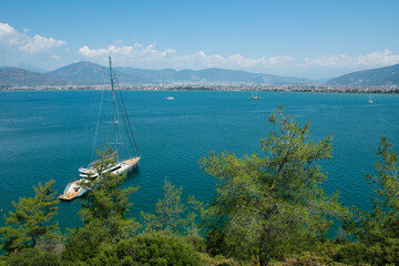  Excursion and fishing boats anchored in the sea. Boats anchored in the bay. Green bays of Antalya....