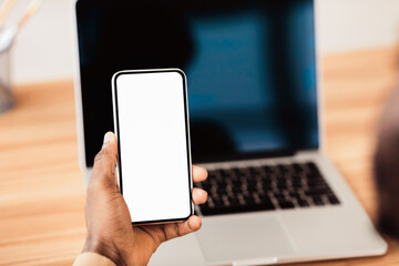 Modern Technologies. Unrecognizable black businessman holding smartphone with blank screen, mock up