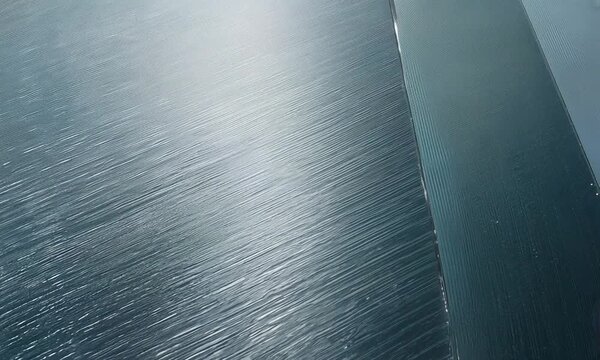 Textured Glass Surface: Diagonal Lines and Light Reflection.