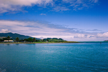 Obraz premium View over holiday park across sheltered bay at Tawatahi River. Raglan, New Zealand