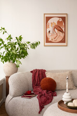Cozy living room with a beige sofa adorned with textured and patterned pillows. A framed art piece...