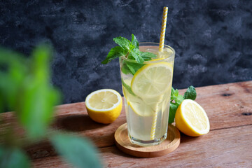 Glass of lemonade with fresh lemon sliced and mint leaf for summer drink.