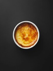creme brulee. top view. stylish minimalist composition. isolated on a black dark background, copy space