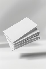 A stack of blank white paper sheets creatively suspended against a minimalist background.