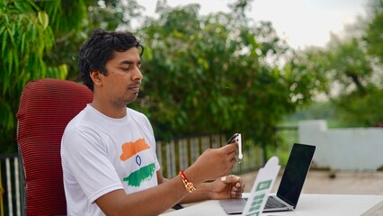 Indian young man doing payment with smartphone using QR code
