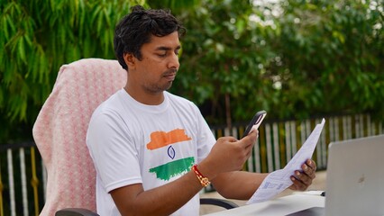 Indian young man doing payment with smartphone using QR code
