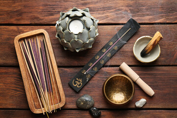 Flat lay composition with incense sticks on wooden table. Om ligature