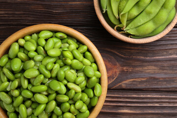 Raw green edamame soybeans and pods on wooden table, top view
