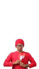 Indonesian youth holds a moment of silence while holding the Indonesian flag, remembering the struggle of the heroes who have fallen for Indonesia independence Day, isolated on a white background