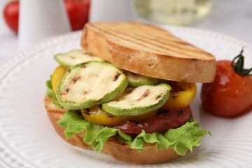 Tasty sandwich with grilled vegetables on table, closeup