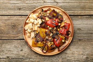 Delicious salad with grilled vegetables on wooden table, top view