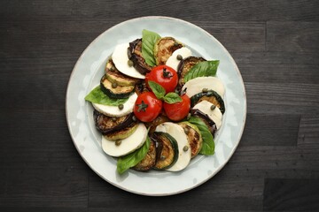 Tasty salad with grilled vegetables and mozzarella cheese on wooden table, top view