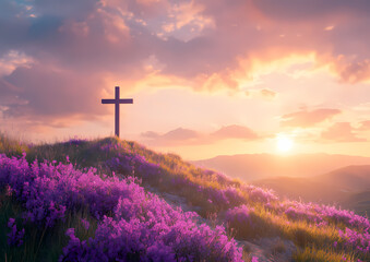 Cross atop a hill surrounded by purple flowers at sunset