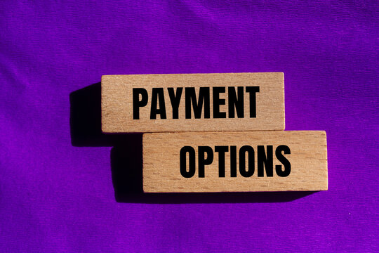 Payment options message written on wooden blocks with purple background. Conceptual payment options symbol. Copy space.