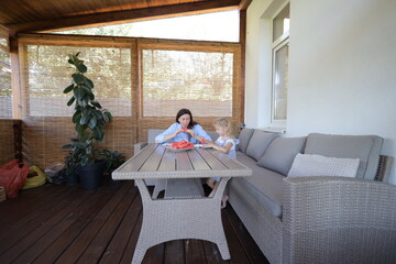 Mother and a child eating watermelon