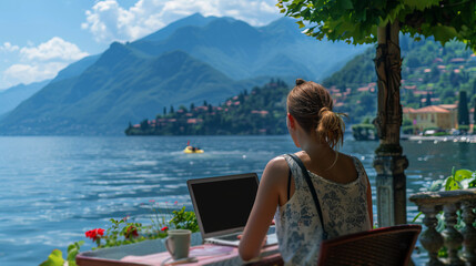 A young woman works on her laptop at a cafe