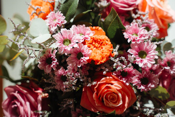 Modern fresh orange and pink bouquet in direct sunlight