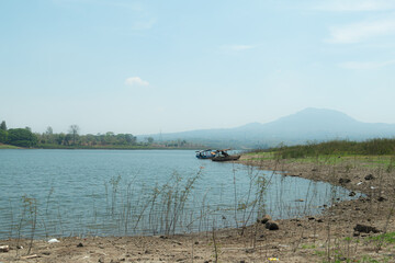 Boat landscape on a lake with a mountain background