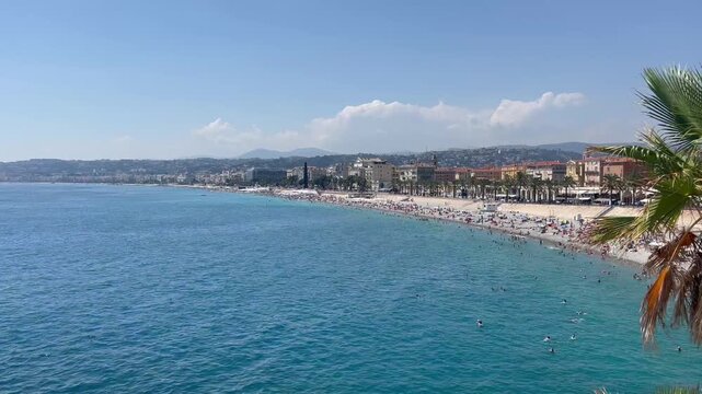 Beach in Nice, France. View of nice beach and promenade des Angles. Nice, Cote d'Azur. Promenade des anglais at sunset. French Riviera. European summer vacation, holidays concept. Mediterranean Sea