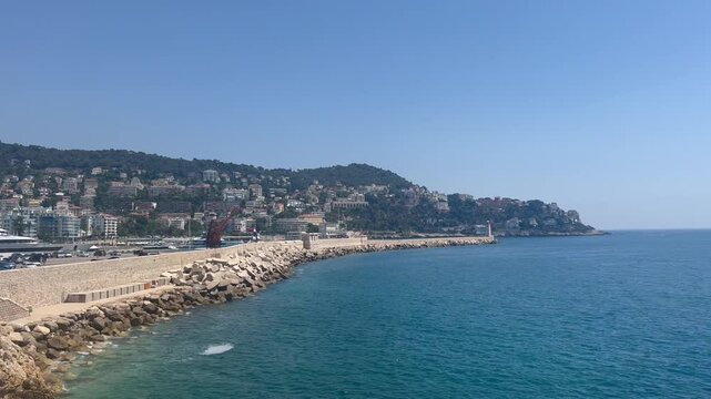 Beach in Nice, France. View of nice beach and promenade des Angles. Nice, Cote d'Azur. Promenade des anglais at sunset. French Riviera. European summer vacation, holidays concept. Mediterranean Sea