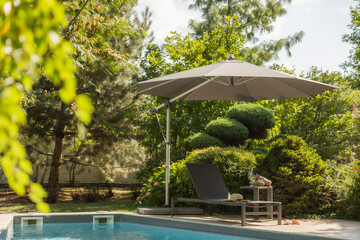 outdoor furniture sun umbrella pool trees background