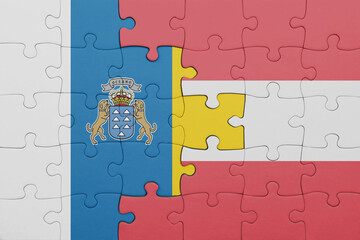 puzzle with the colourful national flag of austria and flag of canary islands.