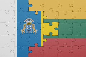 puzzle with the colourful national flag of lithuania and flag of canary islands.