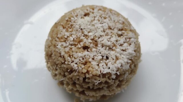 Steamed rice cake, yellow wheat puttu, pittu or putt popular traditional native vegetarian dish for breakfast and dinner in the south Indian states of Tamil Nadu and Kerala. Closeup rotating top view.