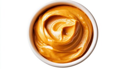 Fototapeta premium Smooth pumpkin puree in a white dish swirled with cream and dusted with nutmeg isolated on white background cozy fall colors 