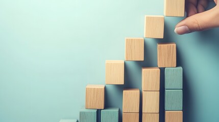 Strategic business growth concept with hand placing green and blue blocks to build an upward graph representing success in marketing and sales. Business planning, and positive trends