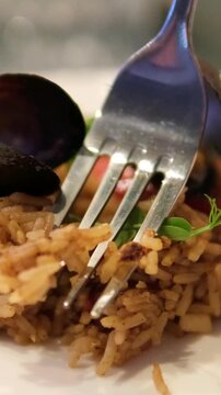 oriental seafood fried rice and cold teh tarik with wooden pattern table. Spanish paella with shrimps and chorizo. rice with seafood