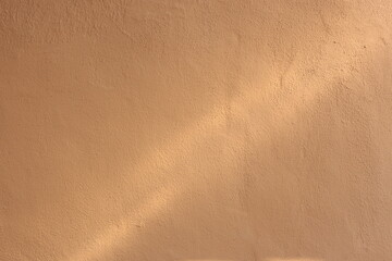 Soil wall texture of clay house structure with sunlight. Mud background
