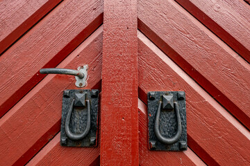 Oregrund, Sweden A red wooden door with iron knockers.