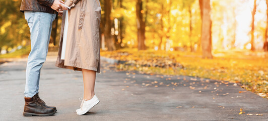 Cropped of couple standing face to face, autumn forest background