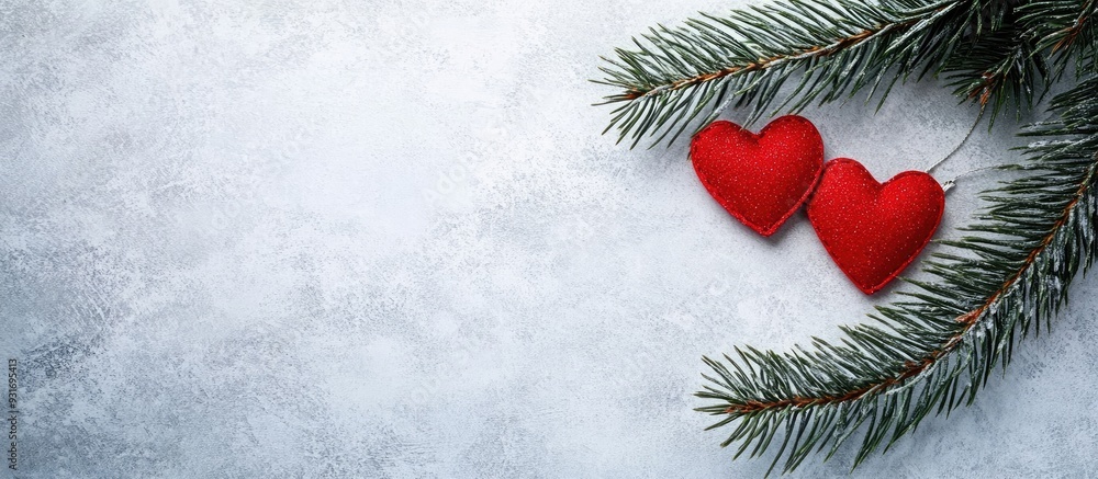 Poster christmas tree branch with two red hearts on light gray paper a representation of love and lovers fo