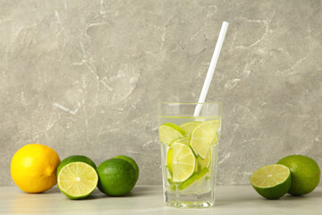 Glass of fresh mojito on grey background. Space for text