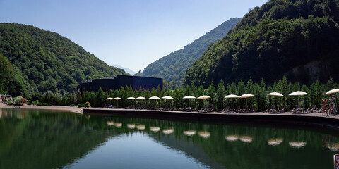 Fototapeta premium sun loungers at the pool with umbrellas